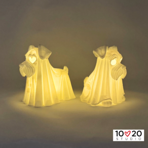 Two Standing Ghostly Schnauzer lanterns glowing from different angles with LED tealights